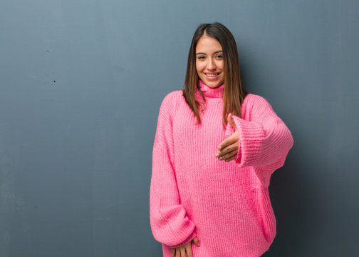 Young Modern Woman Reaching Out To Greet Someone