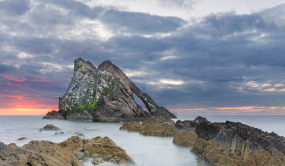 Bow-fidle Rock sunrise landscape on the coast of Scotland on cloudy morning