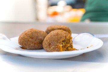 Boiled stuffed meatballs preapred with cracked wheat, semolina, minced meat and spices, outdoor, close up