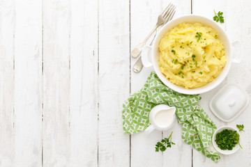 Mashed potato with butter and milk on table