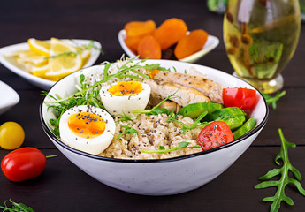 Fresh salad. Breakfast bowl with oatmeal, chicken fillet, tomato, lettuce, microgreens and boiled egg. Healthy food. Vegetarian buddha bowl.