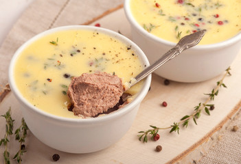 Liver pate with butter in a portion of small dishes. Served individual. Rustic style and natural napkin. Horizontal view.