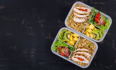 Lunch box  chicken, bulgur, microgreens, tomato  and fruit. Healthy fitness food. Take away. Lunchbox. Top view