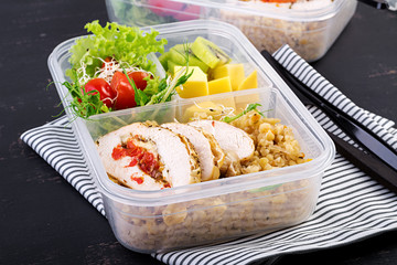 Lunch box  chicken, bulgur, microgreens, tomato  and fruit. Healthy fitness food. Take away. Lunchbox.