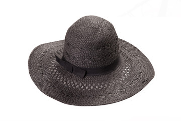 Pretty straw hat with ribbon and bow on white background. Beach hat top view isolated