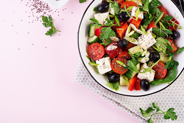 Greek salad  with cucumber, tomato, sweet pepper, lettuce, green onion, feta cheese and olives with olive oil. Healthy food. Top view