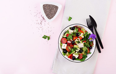 Greek salad  with cucumber, tomato, sweet pepper, lettuce, green onion, feta cheese and olives with olive oil. Healthy food. Top view