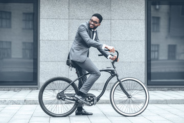 Businessman riding bicycle to work in morning