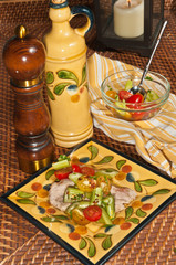 front view, close up of a freshly prepared, homemade, german pancake in a cast iron fry pan with female hand shaving lemon skins over top on a wood cutting board