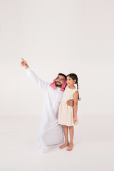 Arab father with his daoghter showing her something