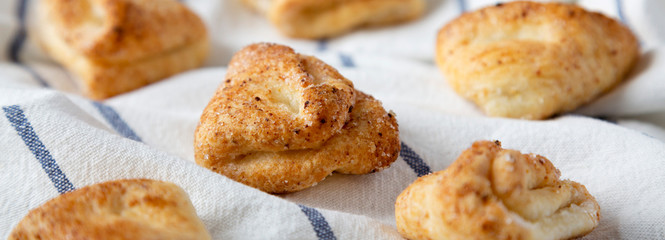 Home-baked cottage cheese biscuits on cloth, side view. Close-up.