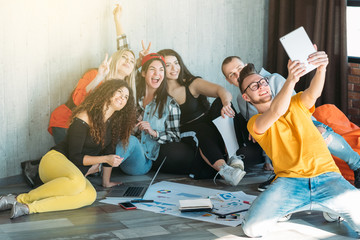 Young business team break time. Youth freedom lifestyle and leisure. Friendly relaxed atmosphere. Guy taking group selfie.