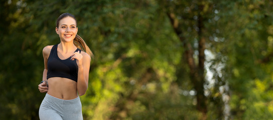 Young millennial woman running in empty park early in morning
