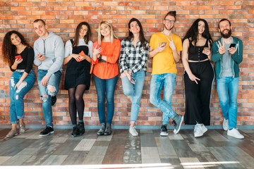Millennials happy wealthy generation. Young cheerful people in casual outfits, standing relaxed,...