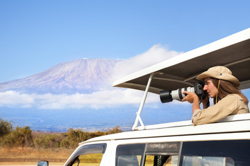 Woman taking shots during Kenyan safari game drive © Sergey Novikov