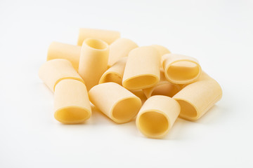 Raw pasta on white surface