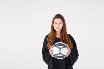 Beautiful Arab woman in traditional dress carrying soccer ball