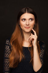 Portrait of a beautiful woman with straight long hair and interesting emotion. Studio photo session