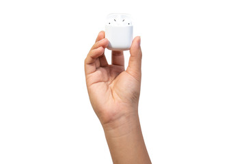 White wireless earphones in-ear or earbud bluetooth with charging case holding in hand isolated on...