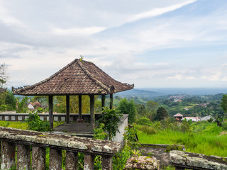 Fototapeta na wymiar Red roofs of an abandoned hotel in Bali. Beautiful landscape.