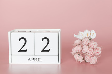 April 22nd. Day 22 of month. Calendar cube on modern pink background, concept of bussines and an importent event.