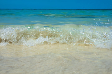 Tropical summer sea wave, sand beach and sky