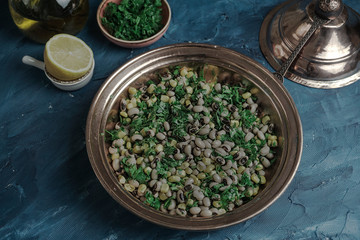 Appetizers dry cowpea salad with corns and parsley on blue background
