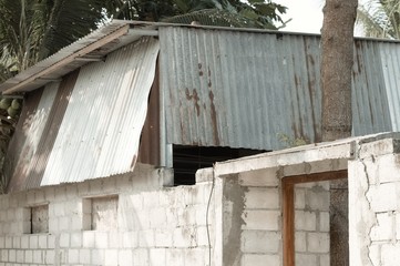 Abandoned building with a rusted steel roof (Ari Atoll, Maldives)