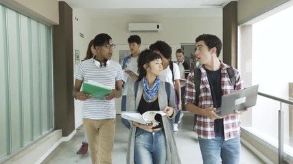 Point of view shot of college students sharing notes while walking in college corridor - Powered by Adobe