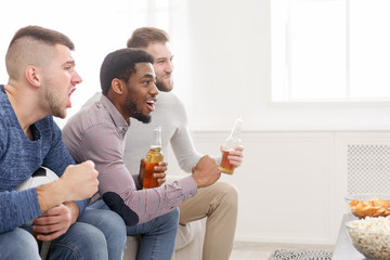 Diverse football fans cheering for favourite team at home