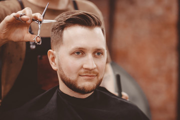 Barbershop banner. Man in barber chair, hairdresser styling his hair.