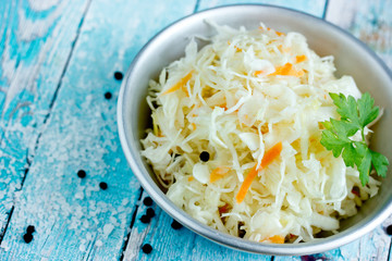 Homemade sauerkraut with carrot and spices, sweet and sour white cabbage
