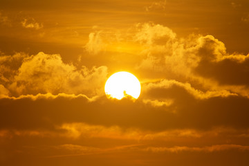 Early morning sun shining through clouds in dramatic colors