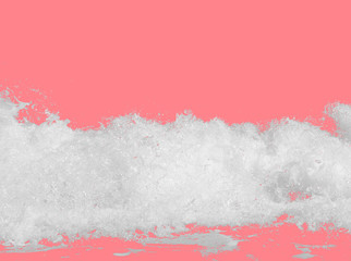 white sea foam from the surf, isolated on bright pink background, the concept of summer beach vacations with carbonated drink, travel, relaxing on the seashore