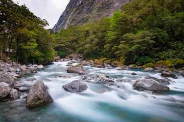 Long exposure shot of a creek running nearby Milford Sound, South Island, New Zealand