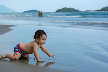Baby boy in the beach fun traveling with kids funny smile