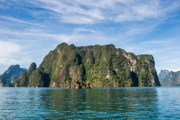 Beautiful nature rock mountains cliff and blue emerald water color lake river with blue clear sky in Ratchaprapa Dam at Khao Sok National Park, Surat Thani Province, Thailand. Asia tourism location.