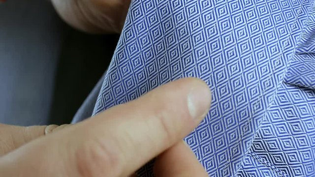 Man takes off cufflink cloce up
