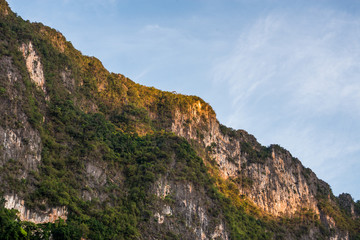 Fototapeta na wymiar Beautiful nature rock mountains cliff with blue clear sky in Ratchaprapa Dam at Khao Sok National Park, Surat Thani Province, Thailand. Asia tourism location.