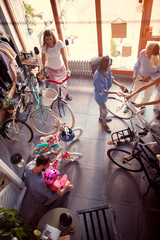 Young father buying new bicycle for little girl in bike shop top view.