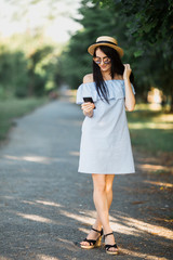 Woman walk in park and using phone.