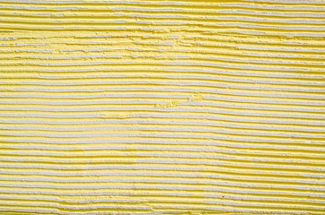 New yellow relief plaster on wall closeup