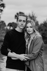 Romantic and Loving Young Adult Couple at the Park Looking At Nature and the Horizon for Portrait Pictures