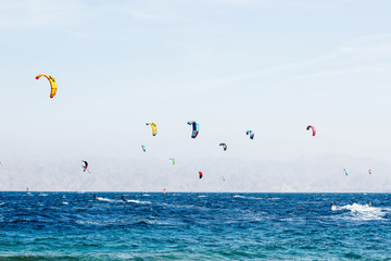 summer vacation and sea activity panorama scenic landscape concept photography with wind surfers people on Mediterranean water surface with empty sky space for copy or text 