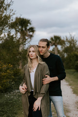 Romantic and Loving Young Adult Couple at the Park Looking At Nature and the Horizon for Portrait Pictures