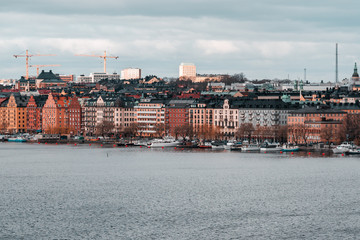 Fototapeta premium buildings at Norr Malarstrand at the coast of Stockholm city with boats at quay, Sweden