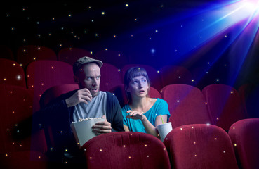 Naklejka premium Lovely couple watching 3D movie with little sparkling stars around