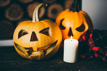 Halloween pumpkin with candle on wood background. Symbol of halloween.