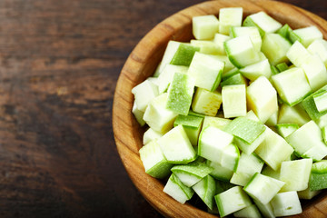 sliced zucchini on wooden background
