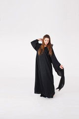 Beautiful Arab woman in traditional dress dancing